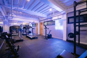 a gym with several treadmills and machines in a room at Canopy Agutaya BGC in Manila