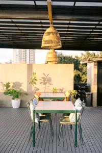 a table and chairs on a patio with a light fixture at Canopy Agutaya BGC in Manila +16 photos