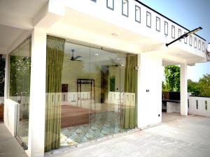a glass extension of a house with a balcony at Sandaruwan villa in Ratgama Hegoda