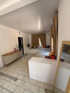a large room with two beds and a room with at Temporada Verão in Prado