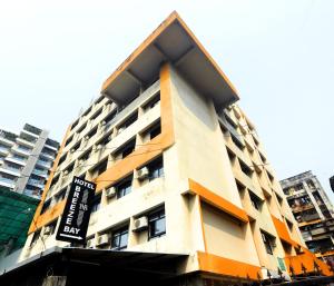 a building with a sign on the side of it at HOTEL BREEZE BAY EX - NEAR US Consulate, BKC in Mumbai