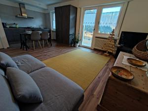 a living room with a couch and a table at Tra prati e monti - Dolomiti Bellunesi in Valle di Cadore