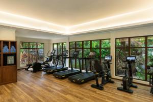 a gym with a row of treadmills and elliptical machines at Niva Labriz Seychelles in Silhouette Island
