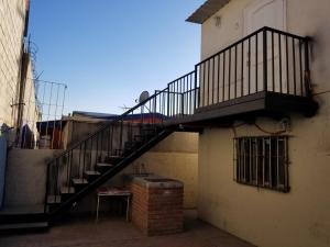 a staircase on the side of a building with a window at Depa Jardines Anahuac in Mexicali +6 photos