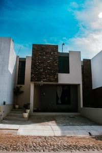 ein Haus mit einem Gebäude mit einem Dach in der Unterkunft Casa Fénix in Comala