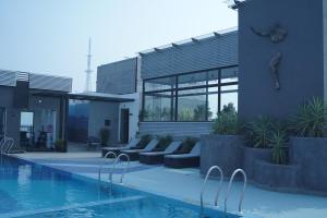 a house with a swimming pool next to a building at Royal Bishnu in Baharampur