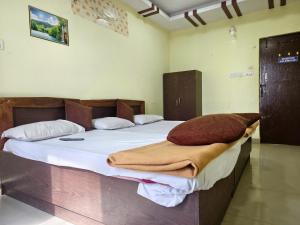 a bedroom with a large bed with a blanket on it at KEBA Dream Grand in Secunderabad