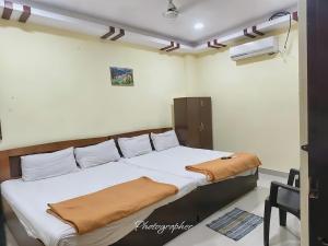 a bedroom with a large bed with white sheets at KEBA Dream Grand in Secunderabad +7 photos