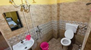 a bathroom with a toilet and a sink at KEBA Dream Grand in Secunderabad