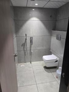 a bathroom with a shower and a toilet at Hotel Shivalik inn in Ankleshwar