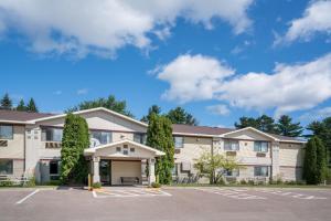 a large apartment building with a parking lot at Super 8 by Wyndham Cloquet in Cloquet