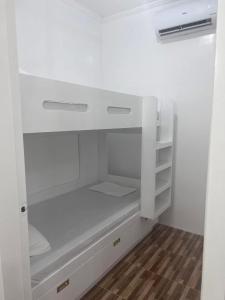 a white closet with white cabinets and a wooden floor at Kole & Kobe Haven in Dipolog