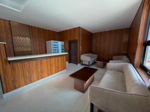 a living room with a couch and a table at Tura Residence Al Khaleej- ترى للشقق المخدومة الخليج in Riyadh
