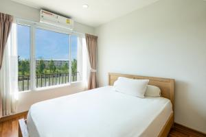 a bedroom with a white bed and a large window at Spacious 3BR BKK NEAR 3 Private Bathrooms FAMILY STAY in Min Buri