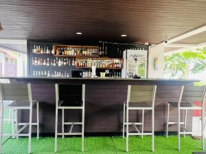 a bar with two chairs and a counter with drinks at Baramee Resortel in Patong Beach
