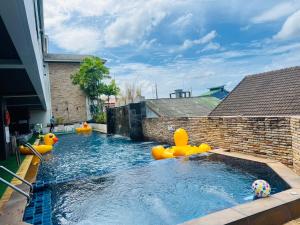 a swimming pool with inflatables in a backyard at Baramee Resortel in Patong Beach