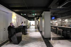 a man sitting at a bar in a restaurant at White Monarch Hotel in Istanbul