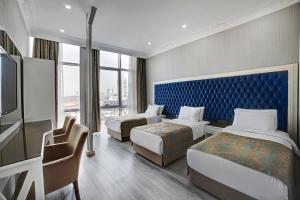 a hotel room with two beds and a tv at White Monarch Hotel in Istanbul +29 photos