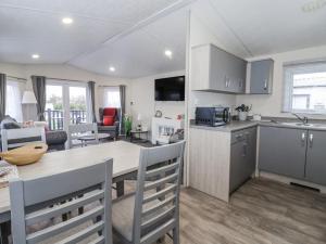 a kitchen and living room with a table and a kitchen and a dining room at Happy Daze in Bridlington