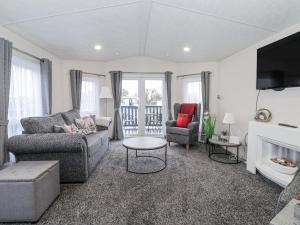 a living room with a couch and a fireplace at Happy Daze in Bridlington