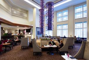 a lobby of a hotel with people sitting at tables at Hyatt Regency Boston in Boston