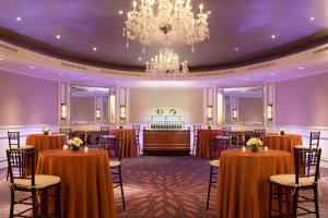 a ballroom with tables and chairs and a chandelier at Hyatt Regency Boston in Boston