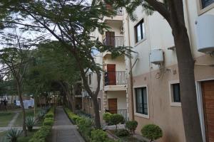an apartment building with trees in front of it at The Luxe Studio in Lusaka