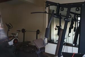a room with a gym with several exercise equipment at The Luxe Studio in Lusaka