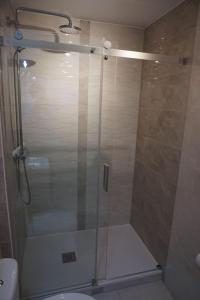 a shower with a glass door in a bathroom at Ferienwohnung Nordig in Garding +9 photos
