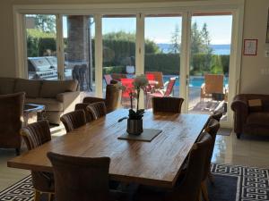 a wooden table with a vase of flowers on it at Luxury accomodation in West Vancouver in West Vancouver
