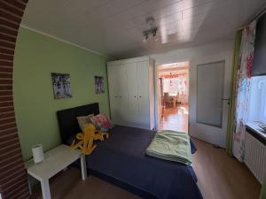 a bedroom with a bed with a yellow flower on it at Golfhues-Simone-EG-Appartement-mit-grossem-Garten in Wulfen auf Fehmarn