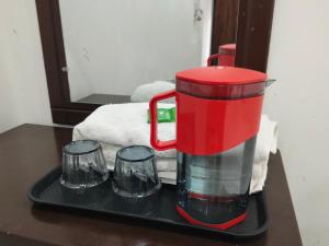 a red blender on a tray on a table at B K Palace in Ayodhya +48 photos