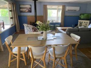 a living room with a wooden table and chairs at Winganna Farm in Peel