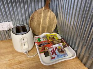a table with a toaster and some food on it at Winganna Farm in Peel
