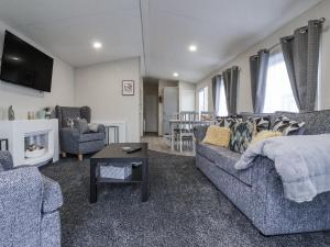 a living room with two couches and a table at Lazy Daze in Bridlington