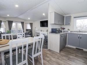 a kitchen and living room with a table and a dining room at Lazy Daze in Bridlington