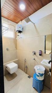 a bathroom with a toilet and a sink at Hotel Vilaasitaa inn Ujjain in Ujjain