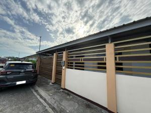 a car parked in a parking lot next to a building at Private Cozy Home in Tagum