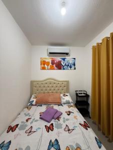 a bedroom with a bed with butterflies on it at Private Cozy Home in Tagum