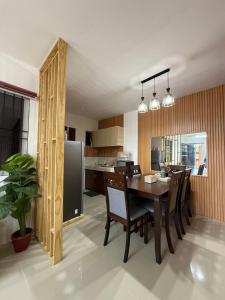 a kitchen and dining room with a table and chairs at Private Cozy Home in Tagum