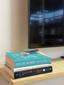 a stack of books sitting on a table at Private Cozy Home in Tagum +3 photos