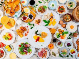 a table full of plates of food on a table at Hotel Flags Sasebo KujuKusima in Sasebo +69 photos
