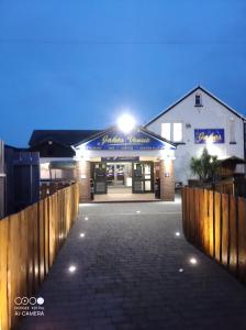 a building with a fence in front of it at K&J's Caravan Rental in Kinmel Bay