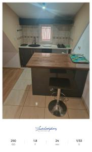 a kitchen with a wooden counter top in a room at Apartament excepțional la casa in Dumbrăviţa