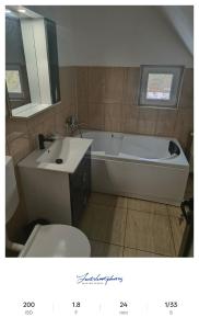 a bathroom with a tub and a sink and a toilet at Apartament excepțional la casa in Dumbrăviţa