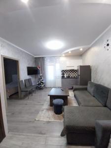 a living room with a couch and a table at TomHouse in Tsaghkadzor