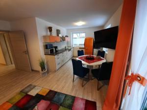 a kitchen and dining room with a table and chairs at Haus-Hempel-1 in Groß Mohrdorf +12 photos