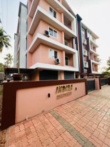 a pink building with a sign in front of it at Mangalore serviced flats in Mangalore