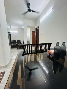 a living room with a couch and a ceiling fan at Mangalore serviced flats in Mangalore