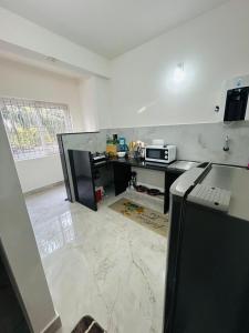 a kitchen with a counter top and a microwave at Mangalore serviced flats in Mangalore